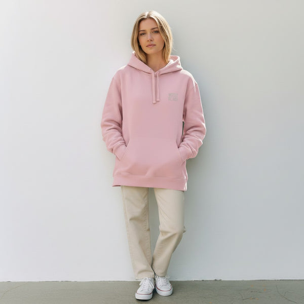 West Cork Folk pink organic cotton blend hoodie with a kangaroo pocket and drawstring hood, worn by a woman.